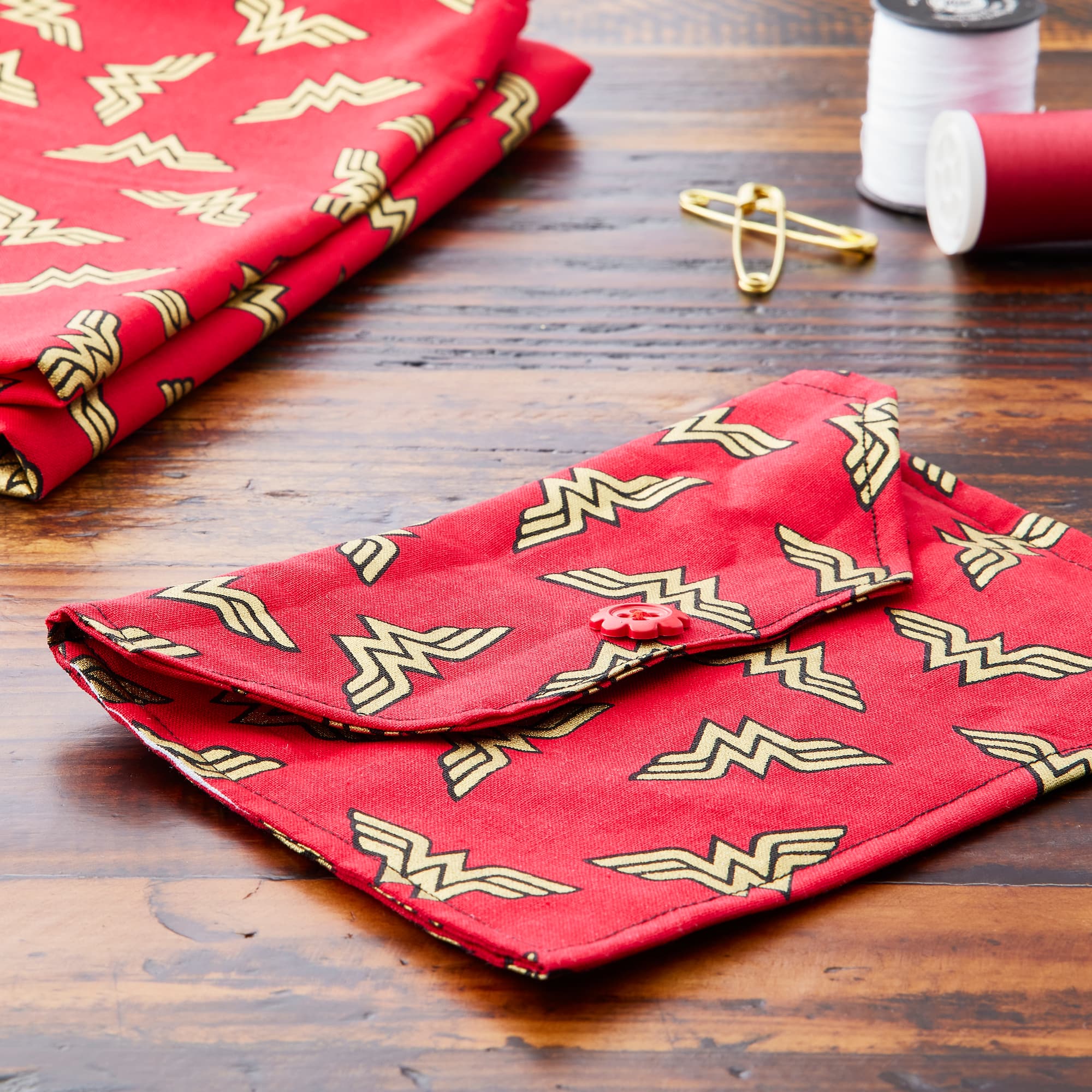 Camelot® Fabrics Metallic Wonder Woman™ Logo on Red Cotton Fabric